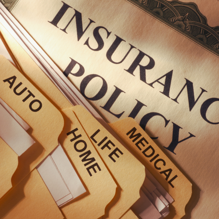 Man reviewing insurance documents at a desk, highlighting the importance of adequate coverage for personal injury cases in 2025.